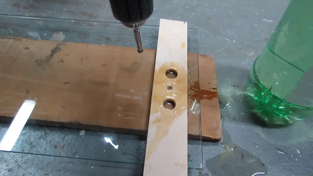 How do you make a hole in a glass bottle without tools?
